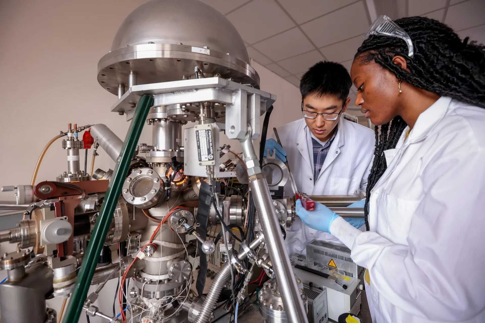 Students loading samples into an x-ray photoelectron spectrometer